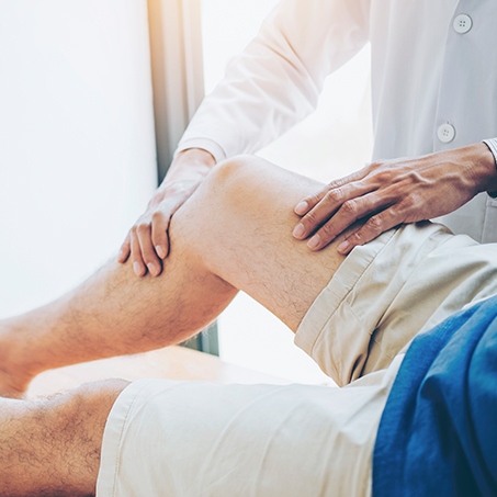 doctor performing knee pain relief for patient